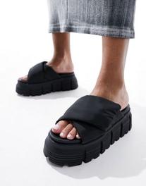 Oferta de Buffalo Ava Velcross flat sandals in black por $132,99 en ASOS