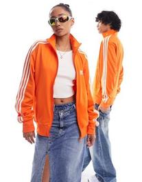 Oferta de Adidas Originals unisex firebird track jacket in orange por $65 en ASOS